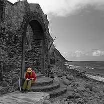 Gaby liest vor den Ruinen von Calhau